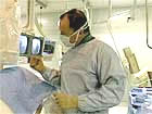 doctor with patient in cath lab