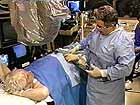 Doctor talks to patient in cath lab